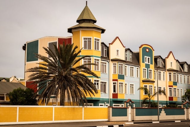 Multicolor Stucco Paint Ideas 8 image of multi-colored stucco on the facade of 4-story house