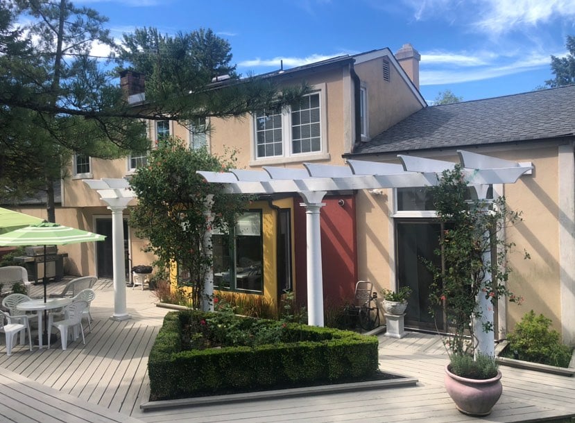 Wayne New Jersey 3 Two-story Wayne NJ stucco home with repaired beige exterior, yellow and red accents, pergola and deck patio