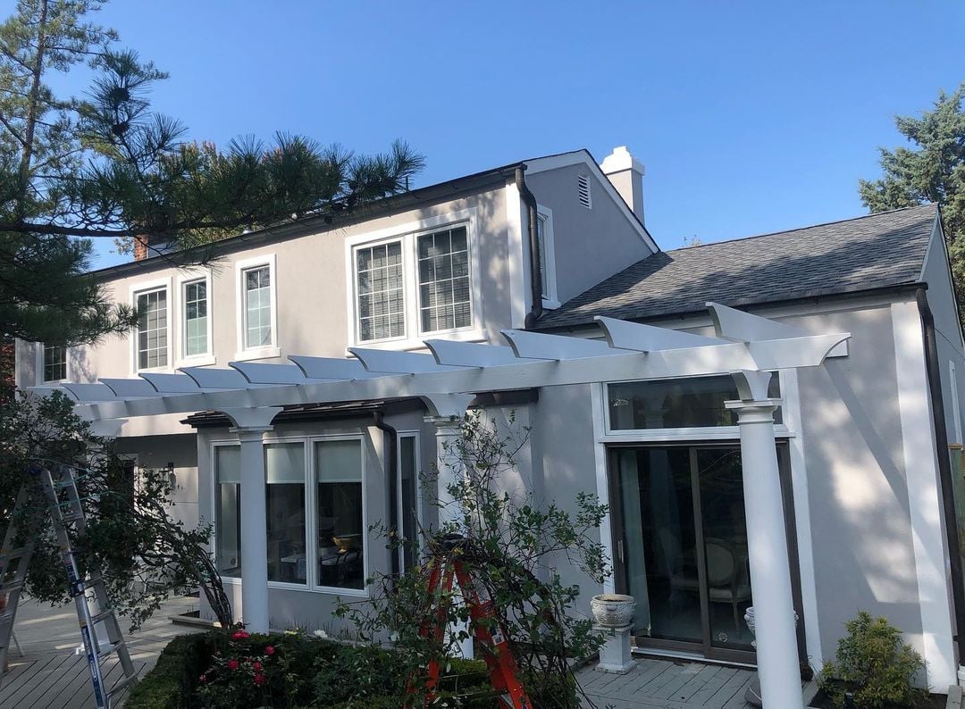 Wayne New Jersey 4 Two‑story Wayne NJ stucco home featuring fresh gray exterior, white pergola and patio with lush garden