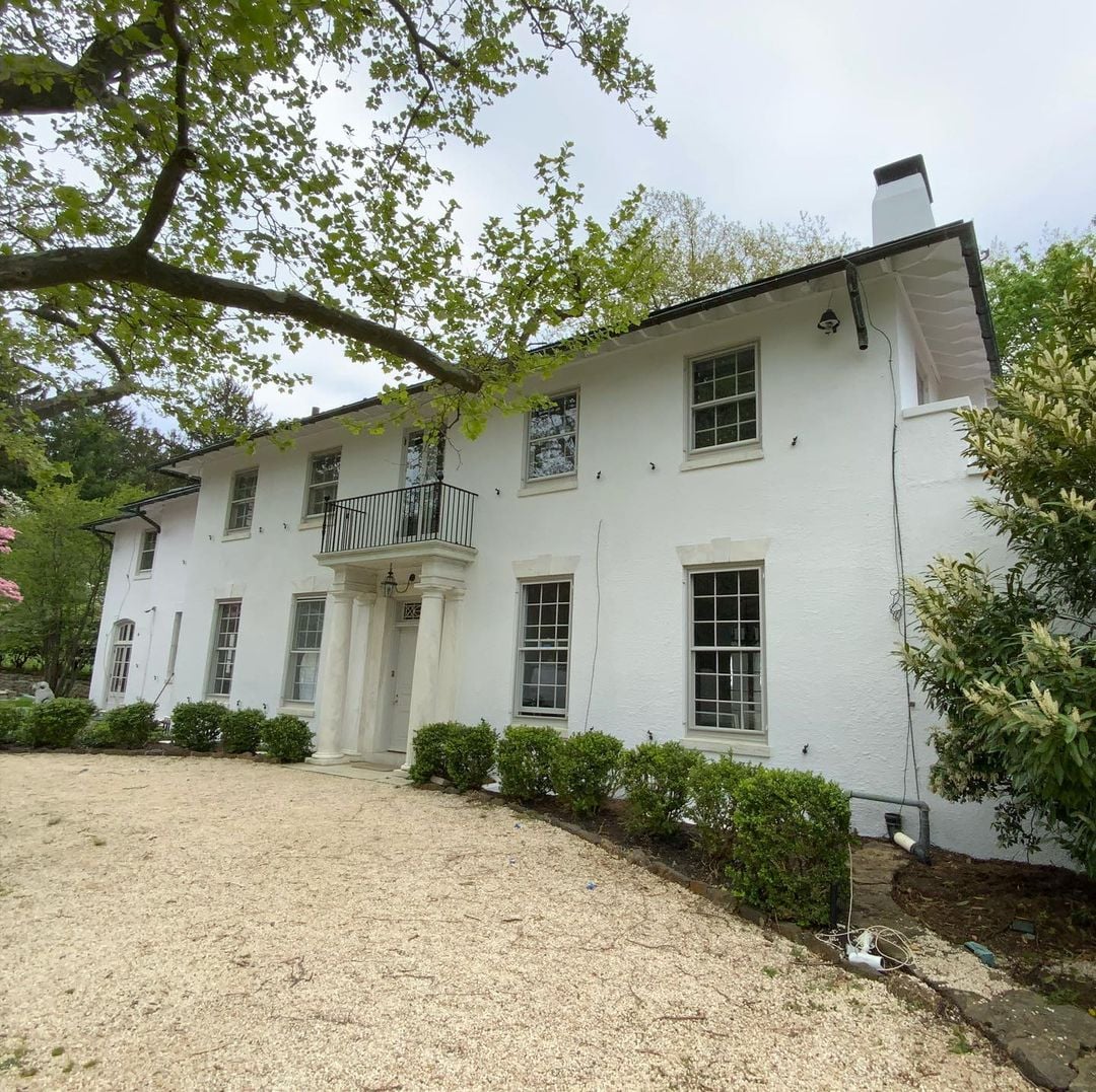 Rumson NJ 4 Rumson NJ home with worn stucco facade, damaged surface and arched porch awaiting professional restoration