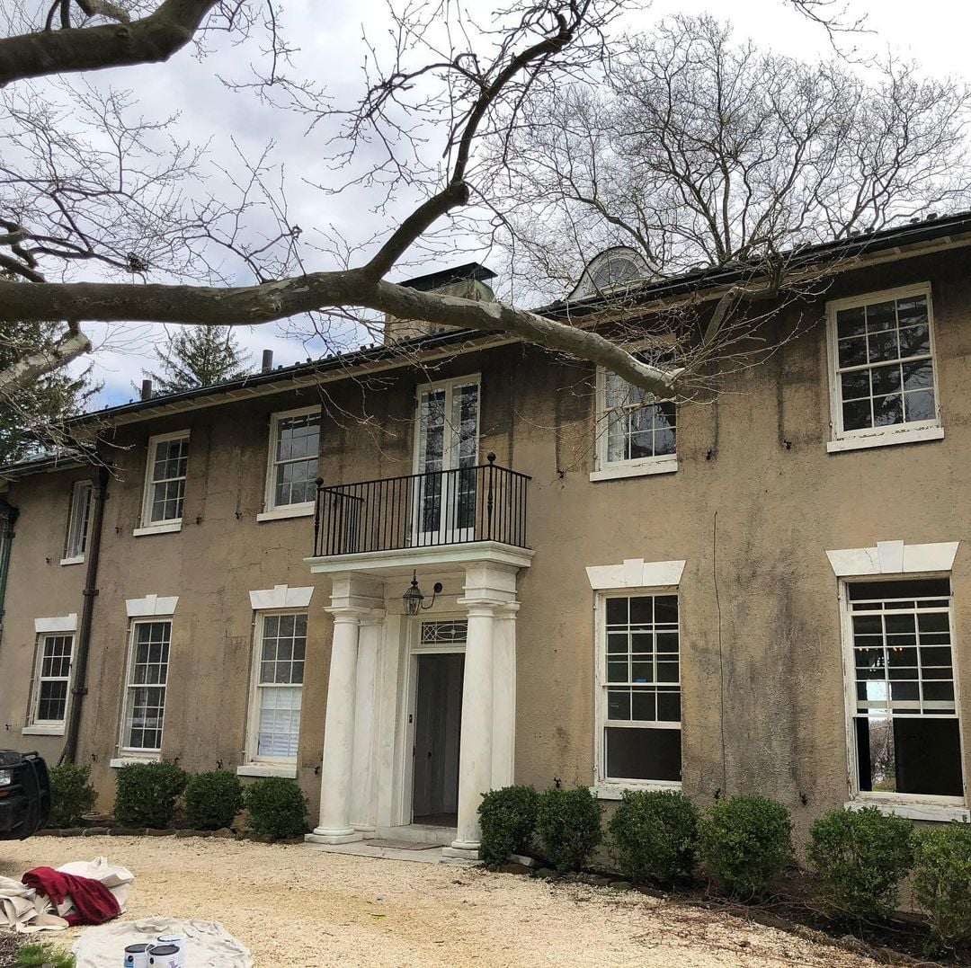 Rumson NJ 3 Rumson NJ home facade with weathered stucco finish showing black streak staining, cracks and worn porch